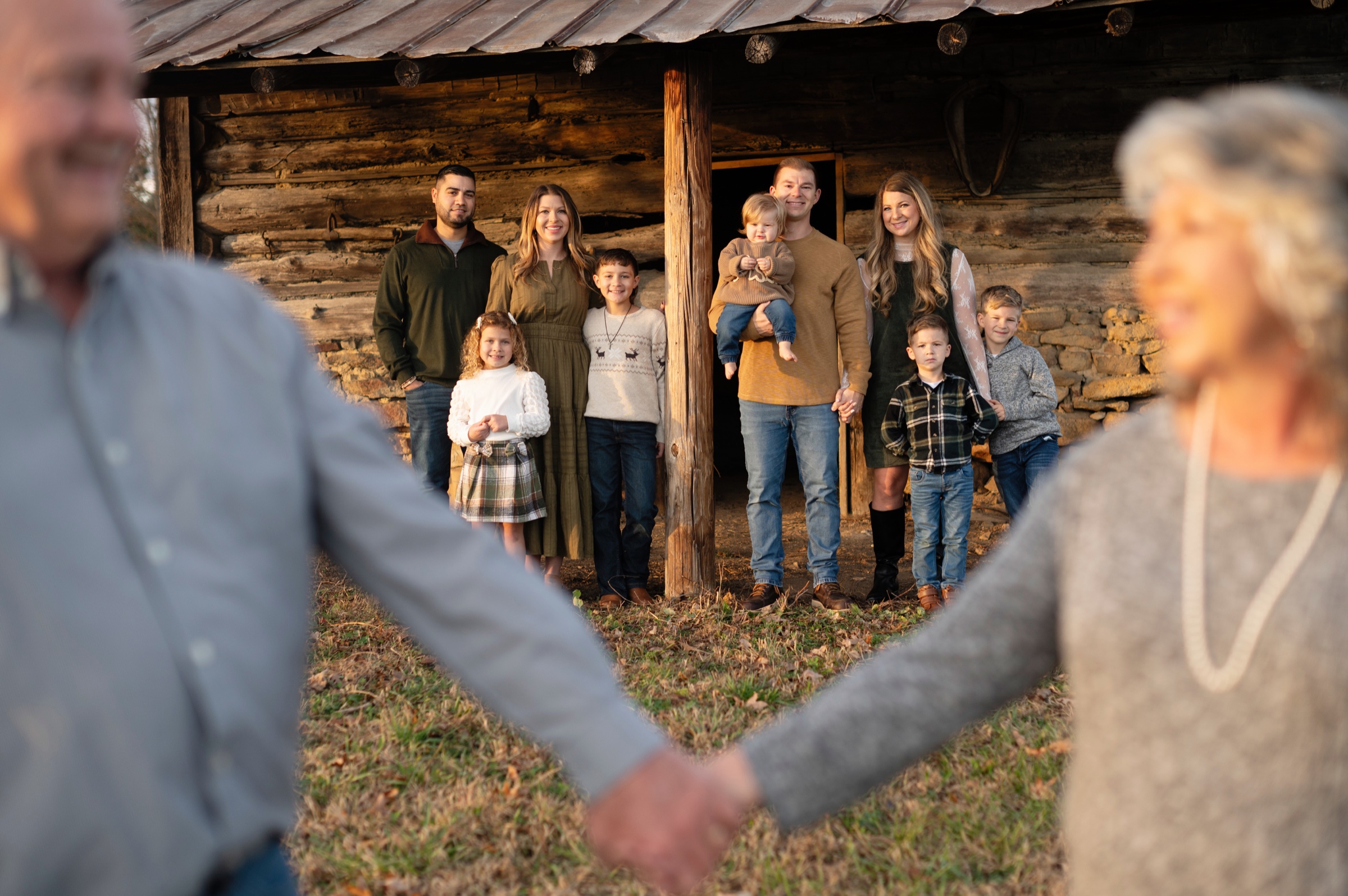 Multi-generational family portrait at a country cabin